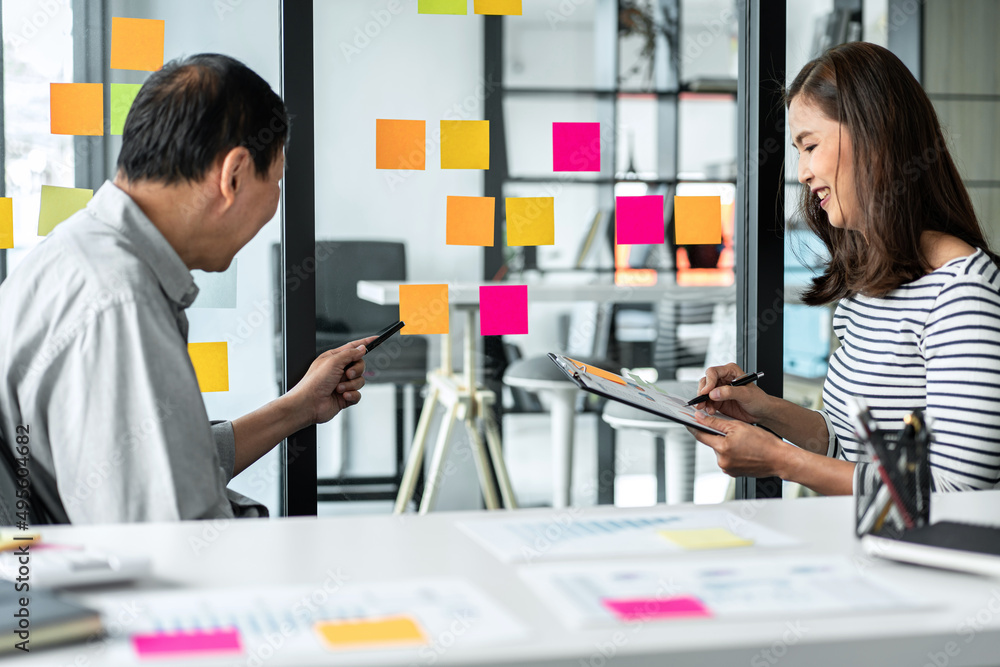 Poster business team pointing on keywords in sticky notes and business report to brainstorming about planni