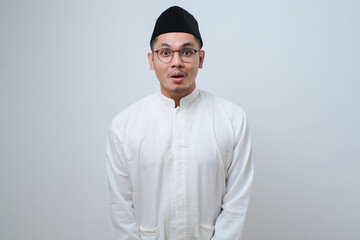 Asian muslim man shocked gesture can not believe of what he sees. Worried expression