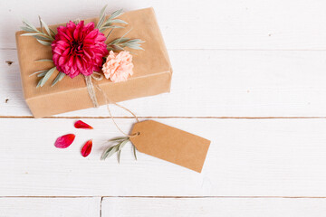 Gift box on the wooden background. Red ribbon. Valentine's Day gift.