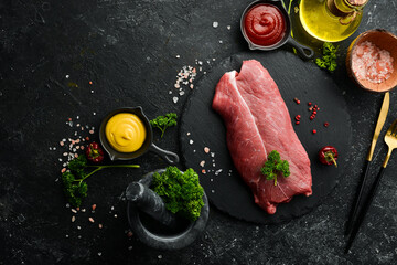 Veal steak. organic raw meat filet beef steak on black slate stone background. Top view. Raw meat.