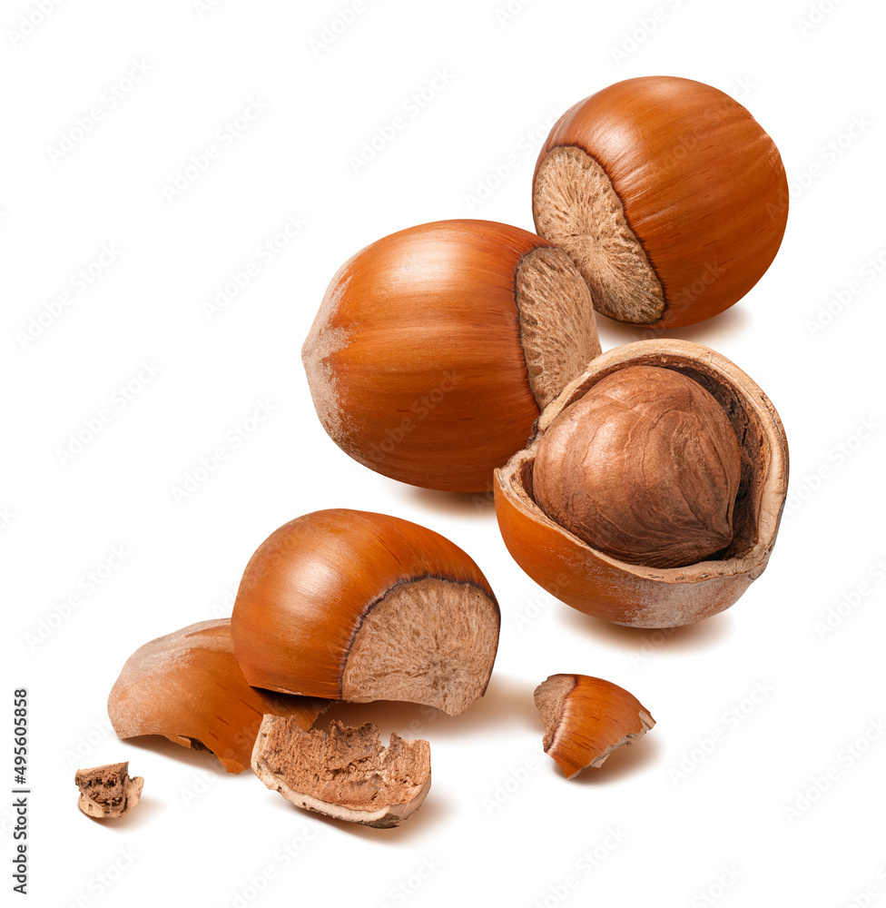 Wall mural whole and broken hazelnuts isolated on white background. nuts, kernels and nutshells for vertical la
