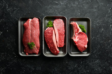 Three juicy raw veal steaks. Banner for the supermarket. Top view. Organic food.