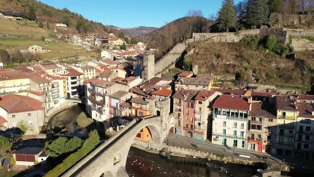 Drone view of the picturesque landscape of the small ancient Catalan town of Camprodon with the famous Roman bridge over the river Ter, Spain.
