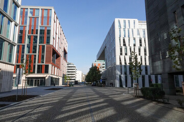 New modern office district in Karolinska street near Vltava river in Prague Karlin, Czech Republic. Street without people and shadows of buildings. High quality photo