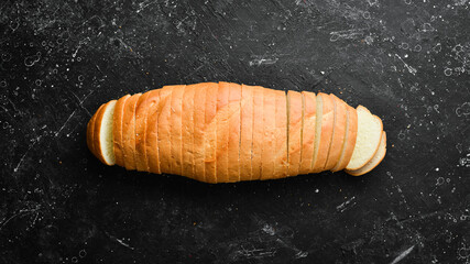 Sliced homemade white wheat bread with wheat flour. Baking from rye and flour. Top view. Rustic style.
