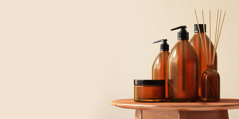 3D render mock up, a set of spa product containers with aroma sticks arranging on a natural wooden table. Blank label, Glass Bottles, Packaging, Bath and body, Skincare, Eco friendly, Recycle, Brown.