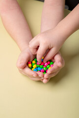 bright colorful sweets in children's palms