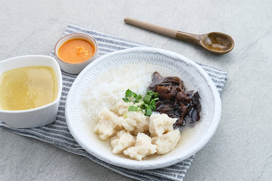 Tekwan, traditional food from Palembang, Indonesia. Made from a mixture of fish meat and tapioca, which is shaped into small balls, with vermicelli, mushrooms, spring onions, celery. Selected focus.
