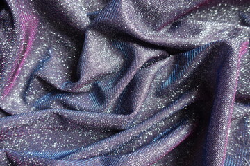 Rumpled shiny purple lurex fabric with pink and blue tinges