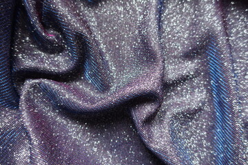 shiny purple lurex fabric with pink and blue tinges in soft folds
