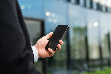 Image of a man holding a mobile phone in his hand