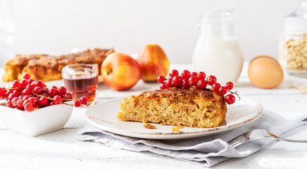 Homemade healthy apple pie with oats, cinnamon and maple syrup as a sweetener, decorated with red currants