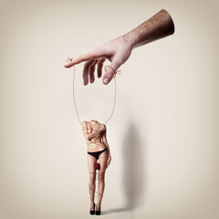 Young woman beautiful constrained with thread headless is a puppet in male hands, conceptual contemporary art collage
