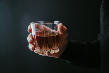 man holding glass of alcohol