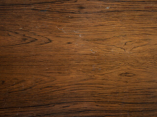 Dark stained wooden table background, rustic wood planks  texture top view. Woodworm attack.