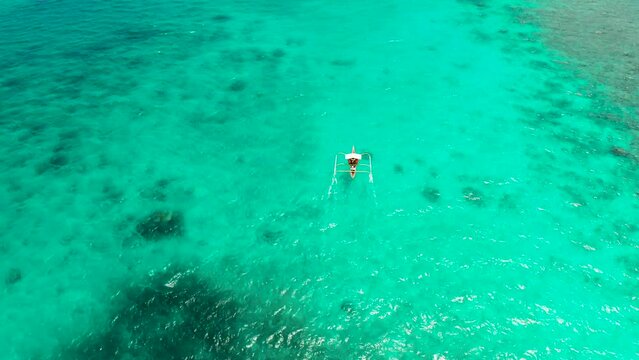 Speed boat on the surface of the lagoon with turquoise water, aerial view. Summer and travel vacation concept.