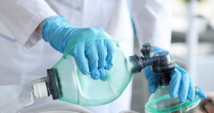 Doctor holding an oxygen mask of patient in emergency room