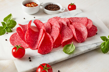 Fresh cut salami on cutting board