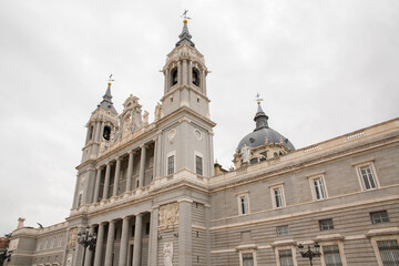 Fototapeta na wymiar Main facade of Almudena Cathedral in Madrid, Spain. On the sides of the facade there are two bell towers. 