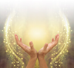 Absorbing Golden Ethereal Energy Healing  -  female cupped hands reaching up into bright white light against spiritual sparkling  background graduated from white to gold to brown and copy space 
