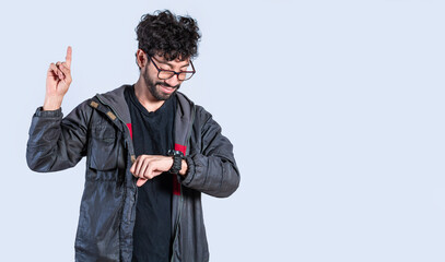 A man raising his finger with a new idea, a guy looking at his watch and raising his finger, a man...