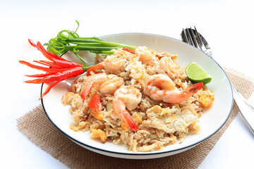 Shrimp fried rice. stir fried rice with shrimp decorate flowers from red chilly peppers, lime and fish sauce on table.Thai food style,Top view. 