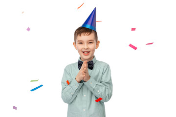 birthday, childhood and people concept - portrait of smiling little boy in party hat clapping hands...