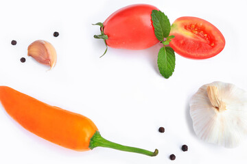 Ingredients for cooking, tomatoes, garlic, black pepper, yellow pepper and mint leaves on white background. Top view.
