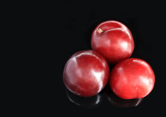 Ripe plums, fresh red plums on dark tone. background of beautiful home plums