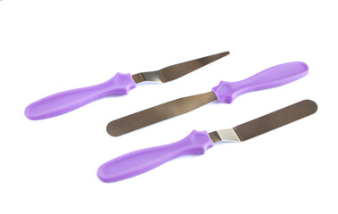 Professional Offset Spatula Set for icing large cakes quickly. starter kit for decorating a cake. Confectioner's tools isolate on white . pastry spatulas. three pieces. High quality photo