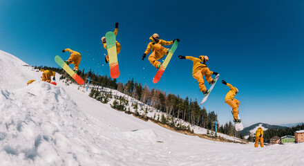 jump storyboard. a guy in an orange suit jumps with a spin on a snowboard and holds a front grab © Denis