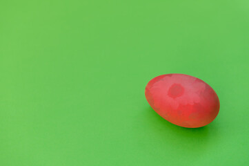 Easter egg on green background. Easter creative layout made with red Easter egg