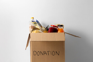 charity, support and concept - close up of food in donation box