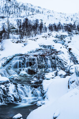Waterfall on the Ersfjordelva river in winter, Ersfjordbotn, Troms, Norway, vertical