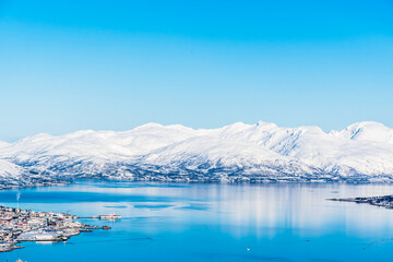 Fototapeta na wymiar View from Mount Storsteinen on the Norwegian mountains around the city of Tromso, copy space
