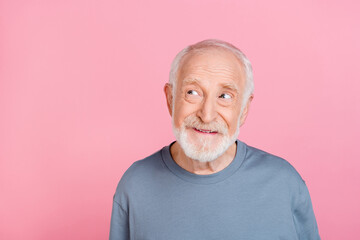 Photo of charming thoughtful retired man grey sweater looking empty space isolated pink color...