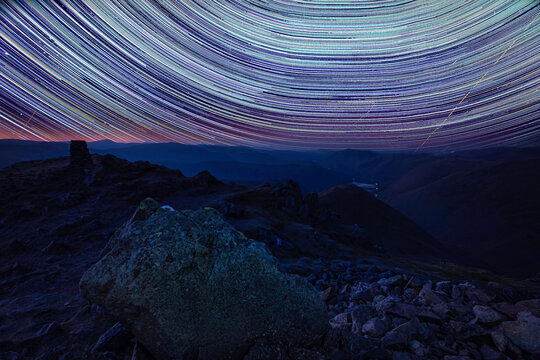Star trails over Red Scares in Lake District, Cumbria, UK. Beautiful nightscape scene. Night under the stars.