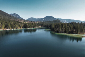 Fototapeta na wymiar Beautiful green lake Hintersee Ramsau Berchtesgardner Land Alps surrounded by mountains and forest