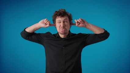 Comical curly man fooling closed ears fingers don't want listening squeamish crazy face expression