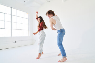 profile of woman and man dancing facing window