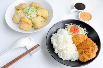 Tonkatsu taken serve with rice. Pork cutlet and shredded cabbage on a plate and fish fried serve with rice on the table. japanese food style
