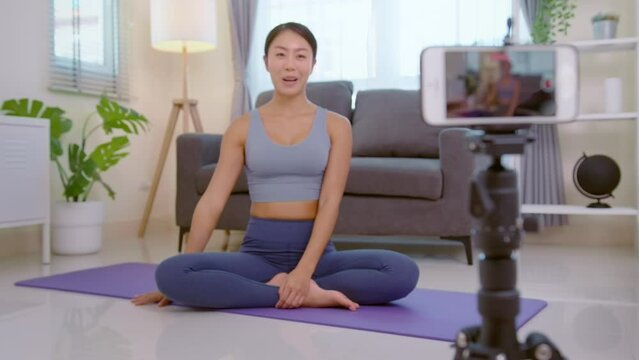 Professional yoga coach teaching online training class to students during live streaming on social media, healthcare concept