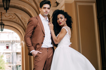 Luxurious wedding couple. Clear, even skin. Photo shoot outdoors with natural light. Portrait of a couple in love in wedding attire.