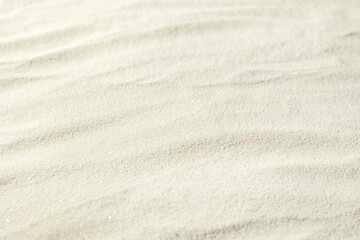 Fototapeta na wymiar Background of light beach sand with shifted focus