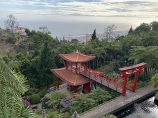Aerial landscape view of a traditional red bridge in Monte Palace Madeira Park in Funchal, Portugal