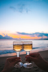 two glasses on the white sandy beach