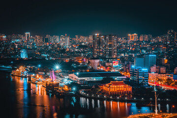 Obraz premium Enjoy the Nha Rong wharf and Bach Dang harbor in Ho Chi Minh City (Saigon). Colorful Saigon river at night.. Travel concept.