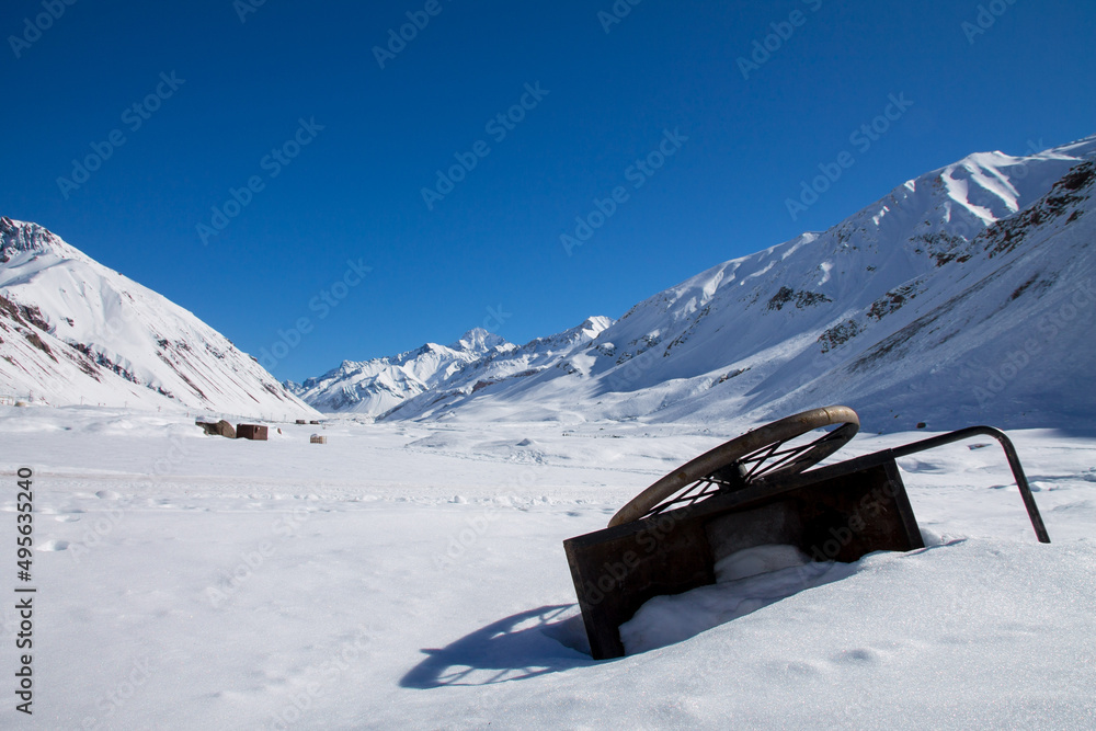 Sticker photo of snowy mountains and a fallen trolley in argentina