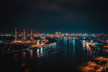 Obraz premium Aerial view of Bitexco Tower, buildings, roads, Thu Thiem 2 bridge and Saigon river in Ho Chi Minh city - Far away is Landmark 81 skyscrapper. This city is a popular tourist destination of Vietnam