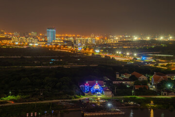 Aerial view of Bitexco Tower, buildings, roads, Thu Thiem 2 bridge and Saigon river in Ho Chi Minh city - Far away is Landmark 81 skyscrapper. This city is a popular tourist destination of Vietnam